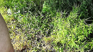 Naked man is surprised while peeing in nature and gets a helping hand