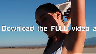 Curvy petite brunette strips at a beach