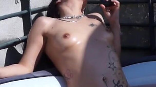 Hot and tattooed brunette is smoking a cigar and masturbating outdoors