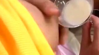 Asian woman squeezes milk from tits