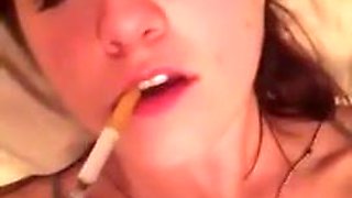 Smoking brunette brings herself to orgasm