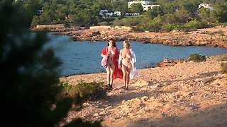 In a kitchen a sexy brunette playing with her big boobs