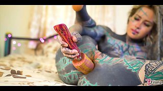 Tattooed girl fingering her pussy and ass