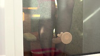 A neighbor observes thru the window, as a COUGAR ravages herself with a faux-cock by the balcony door. Cool arse in rear end-fashion.