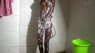 Ebony babe soaps up under the spray then takes it against the tiles