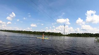 Big-Ass Blonde Rides a SUP Board Naked on a Beach