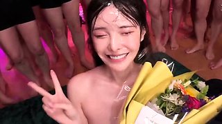 Asian slut drowning in a sea of hard cocks and hot cum