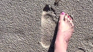 Comparing Size 16 Feet to Sand Prints at the Beach