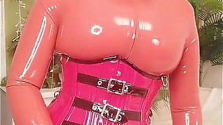 Blonde MILF in Red Latex Rubber Catsuit Teasing with Strap-on