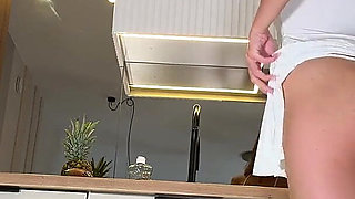 Hottest MILF Real Housewife in a Short Seethrough Sexy White Dress and with a G-string Does Not Cover Her Pussy in the Kitchen