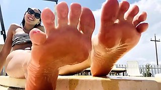 Mistress Gaia feet on a swimming pool