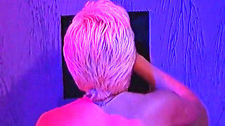 Blonde milf plays with two cocks at glory hole