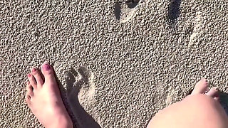Comparing Size 16 Feet to Sand Prints at the Beach
