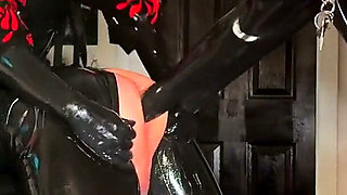 Intermediate Pegging: Two Latex Doms and the Brown Strap-on