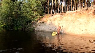 Tattooed Babe Strips and Swims on a SUP Board in the Forest