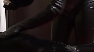 Oil body in latex catsuit